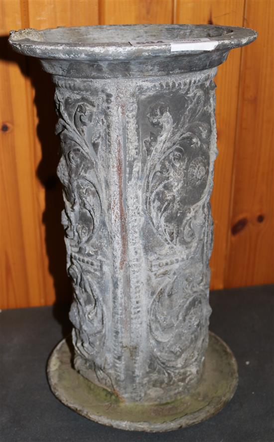 A lead vase, moulded with flowers and leaves